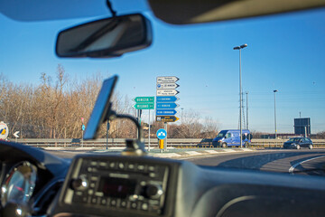 toll road service in Italy through a dirty windshield. Traveling by car in Europed