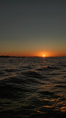 Vibrant sunset painting the croatian sea in orange hues during summer vacation background wallpaper copy space