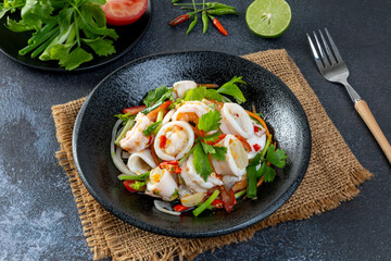 Spicy seafood salad, Thai spicy food recipe, Yum Spicy seafood on the black table