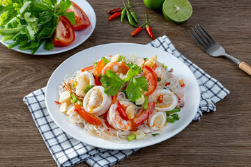 Glass noodle seafood salad on a wooden table