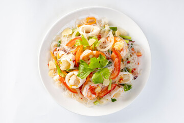 Glass noodle seafood salad on a white background