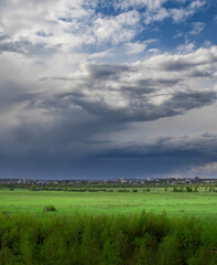 Cloudy sky with a city in the background