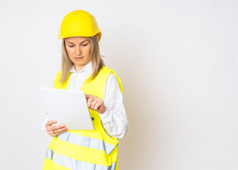 a girl in a yellow jacket and a protective yellow helmet with papers in her hands. High quality photo