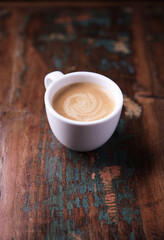 Cup of coffee on wooden background. Soft focus.	