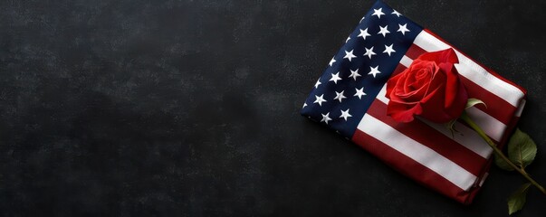Fototapeta premium Symbolic Memorial Day Tribute with American Flag and Red Rose on Dark Textured Background Still Life