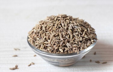 White Cumin Seeds in a Glass Bowl Isolated on White Background with Copy Space