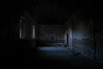 In a dark room, there is a bright light shining down from the ceiling