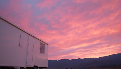 Fototapeta premium mobile clinic stands against vibrant sunset sky in rural landscape Affordable medical procedures.
