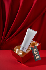 White bottle cosmetic product in red giftbox levitate on red background. mock up design for advertising, seasonal discounts.