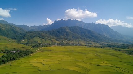 Panoramic view of rice terraces and mountains under a clear blue sky.