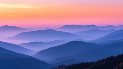 Obraz premium Serene mountain landscape at sunset with layers of misty hills and vibrant sky