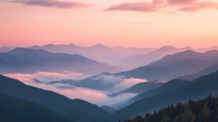 Obraz premium Serene mountain landscape at dawn with misty valleys and pink sky