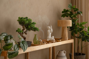 A thoughtfully styled console table with ceramic vases, a burning incense stick, and soft neutral...