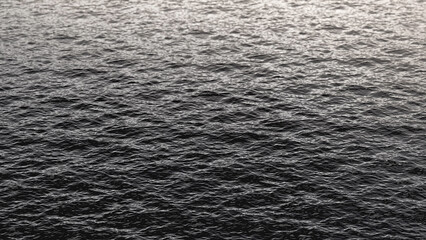 Black sea water background texture, side view