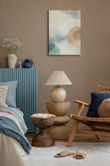 A styled bedroom view with a balanced mix of earthy tones, a textured blue headboard, and soft...