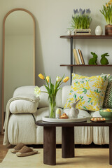 Sunny and design interior of living room with easter decorations, tulips, modular sofa, shelf,...
