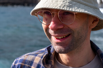 Introspective man stands knee-deep in turquoise waters, Coastal wanderer in checkered shirt and...