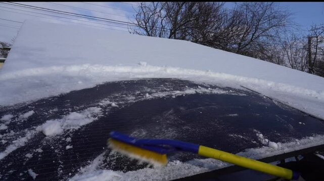 Removing snow from solar panels slowmo
