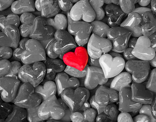 Red Heart Standing Out Among Gray Stone Hearts &ndash; Love, Contrast, Uniqueness