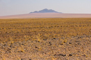 Distant hills, slowly being buried by the encroaching sands in the Namib desert.
