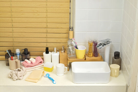 Various props and items placed on a washbasin in a bathroom in a typical home