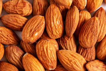 Top view almond nuts layout on white table.