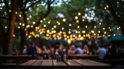 Outdoor dining ambiance with string lights and rustic wooden table in a lively restaurant setting during summer evening