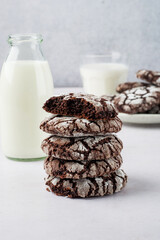 A stack of brownie cookies with milk. Traditional American chocolate brownie cookies..