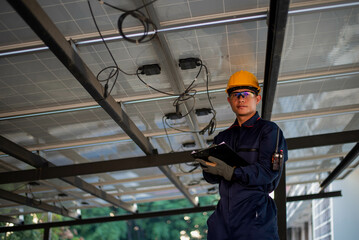An experienced electrician is working hard to check the performance of the solar panels.