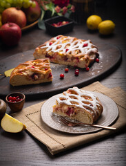 Berry ruddy pie with apples on a dark wooden table