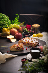 Berry ruddy pie with apples on a dark wooden table