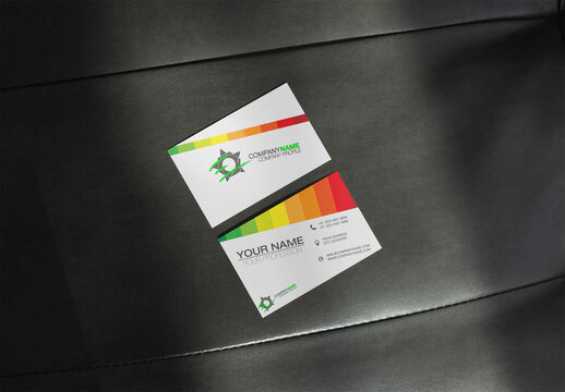 Two business cards are shown on a sleek surface, showcasing their front and back vertical or horizontal designs. Soft texture. EU size 85x55