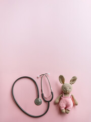 Pink Stethoscope with Cute Crochet Bunny – Pediatric Healthcare and Medical Care Concept - Background with free space