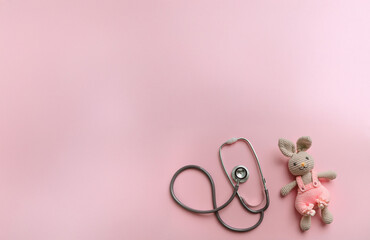 Pink Stethoscope with Cute Crochet Bunny – Pediatric Healthcare and Medical Care Concept - Background with free space