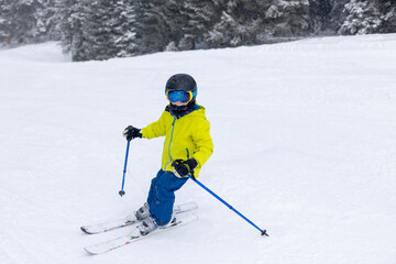 Happy family with kids in winter ski resort, skiing winter time