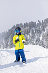 Happy family with kids in winter ski resort, skiing winter time
