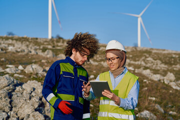 Muslim Woman Engineer and Her Colleague Reviewing a Wind Turbine Project.
