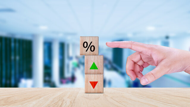 Financial, stocks, interest rate and GDP percent change, wooden block with percentage sign and arrow up sign and down for interest rate, ranking