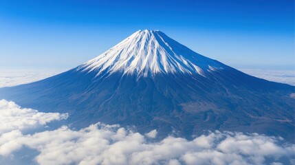 Majestic Mount Fuji: A breathtaking aerial view of Japan's iconic volcano, piercing the clouds under a vibrant blue sky