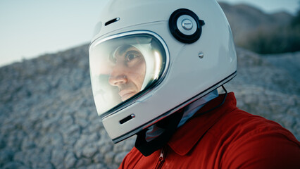 Astronaut With Helmet Looks Around And Opens Helmet Visor In New Planet