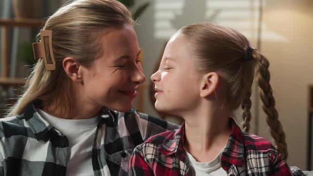 Happy Caucasian family love mother woman female mom babysitter with funny adorable custody adopt child kid girl daughter bonding in living room home smiling touching noses cute sweet moment bonding