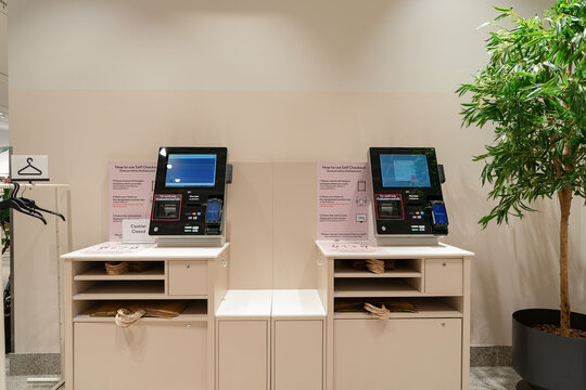 Bangkok, Thailand - October 15, 2024: self-checkout kiosks in H and M at Siam Paragon shopping center, allowing customers to complete purchases independently.