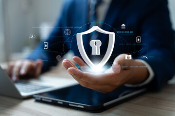 Cybersecurity ยrotection, Business and financial data internet data protection , Businessman using laptop and tablet with digital encryption,  Padlock icon, Firewall, and Secure cloud technology.