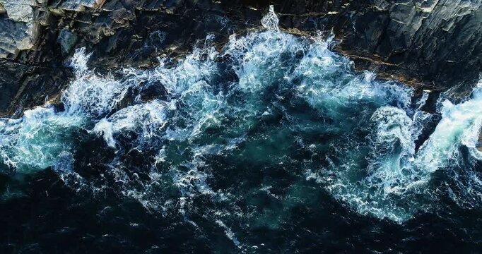 Drone slow-motion footage of storm powerful waves crashing against rocky coastline in Norway, dramatic ocean scenery, 4K aerial view