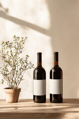 Elegant Wine Display: Two Bottles and a Touch of Greenery in a Warm, Inviting Atmosphere Perfect for Home Decor and Dining Experiences