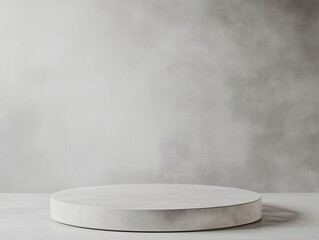 Modern white display podium against a textured gray backdrop.