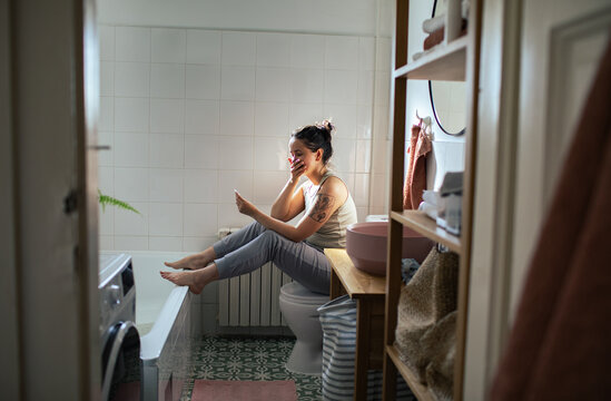 Woman looking at a pregnancy test in the bathroom