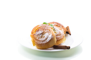 Baked goods. Sweet buns with cottage cheese filling and honey in a plate isolated on a white background