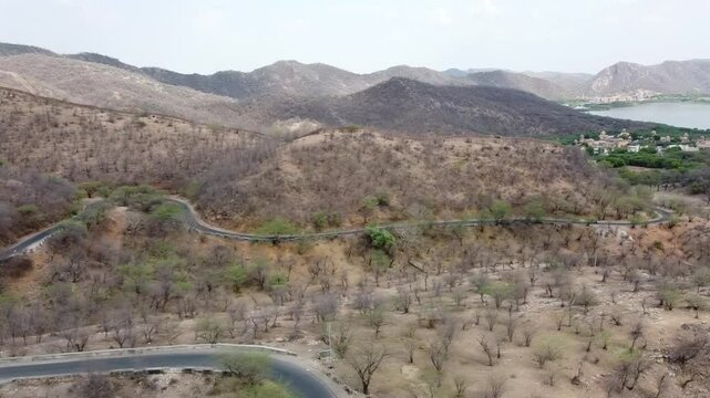 Aerial top view of Aravalli mountain range in Jaipur city of India showing the beautiful landscape along with vehicles on the road 