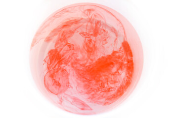 Red ink in water isolated on white background. Abstract background for design.